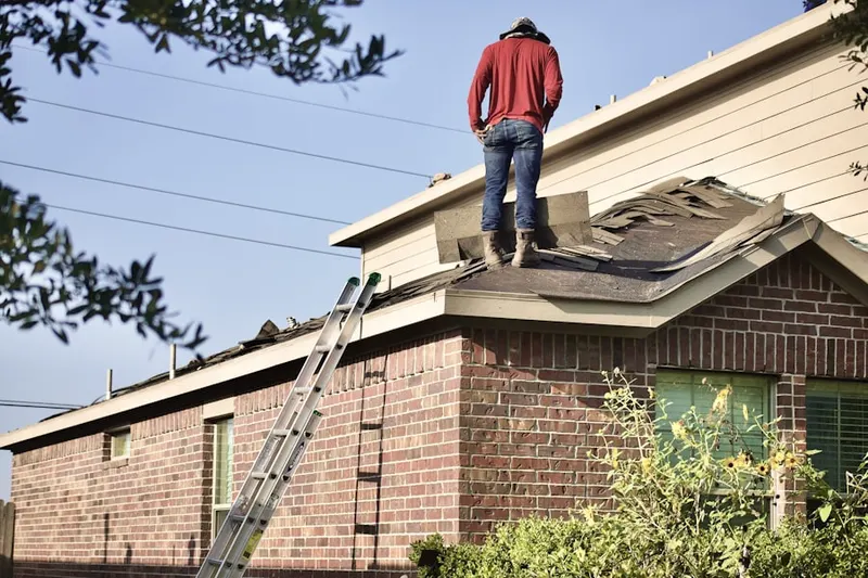 Professional roofer working on a residential roof in Hermosa Beach